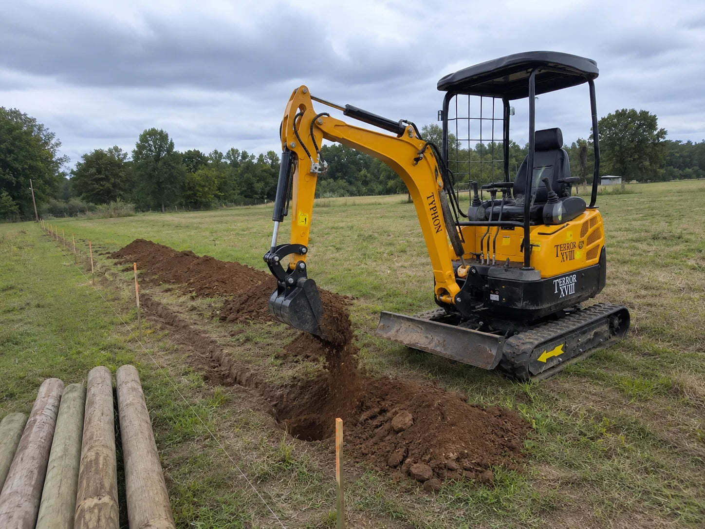 TYPHON TERROR XVIII mini excavator preparing a fence line